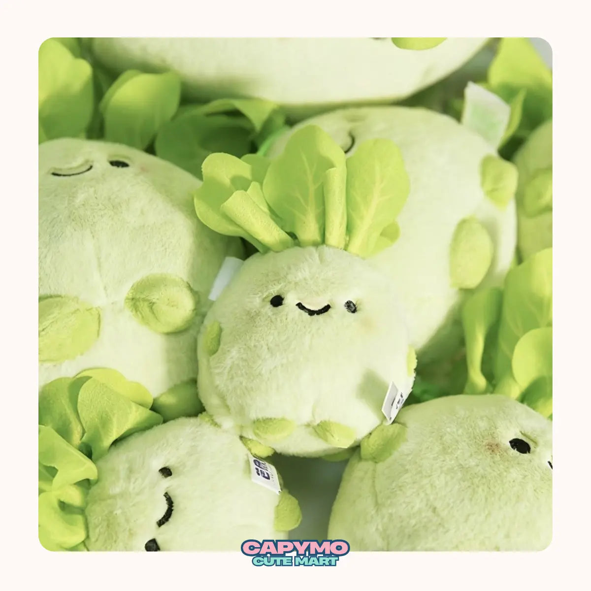 Plush toy resembling a leafy green vegetable with a visible brand logo.