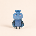 A cute blue felt insect plush toy with a crown, pink cheeks, and dark gray legs and arms, standing against a solid beige background.
