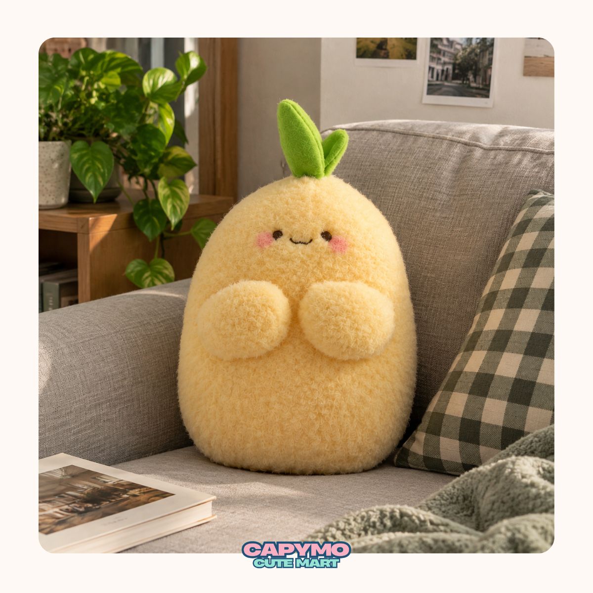 A cute yellow plush pillow shaped like a smiling fruit with green leaves on top, sitting on a gray sofa in a cozy living room setting.